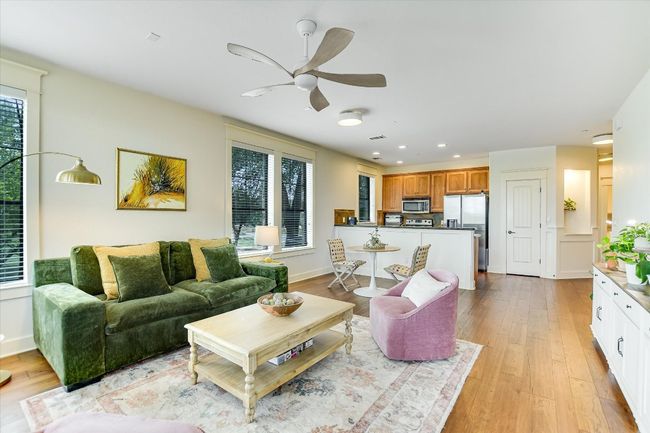 Living area looking to kitchen and dining area. light wood-style flooring, healthy amount of natural light, and recessed lighting | Image 7