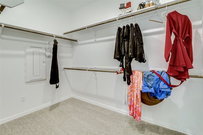 Walk in closet with carpet flooring and electric panel | Image 25