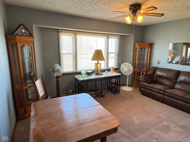carpeted living room with a textured ceiling and ceiling fan | Image 20
