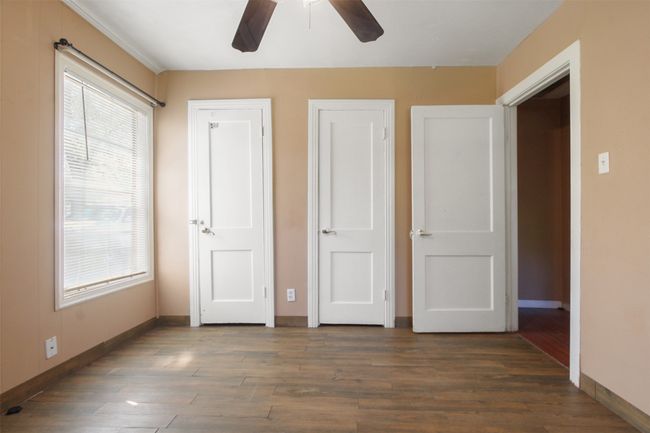 Unfurnished bedroom featuring wood finished floors, baseboards, and a ceiling fan | Image 11