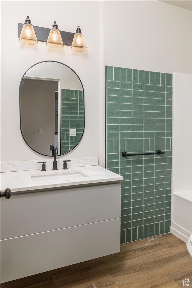 Bathroom featuring a bathing tub, vanity, wood-type flooring, and toilet | Image 30