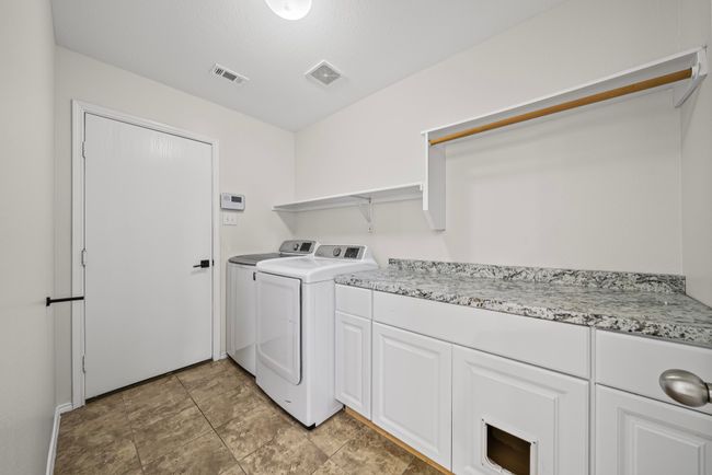 Laundry area featuring washer and dryer and cabinet space | Image 37