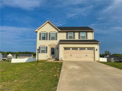 View of front of property featuring a 2 car garage and a front yard | Image 1