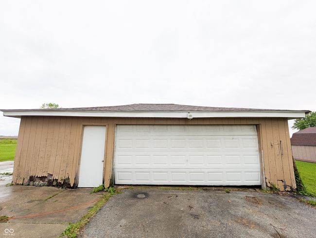 garage featuring asphalt driveway | Image 16