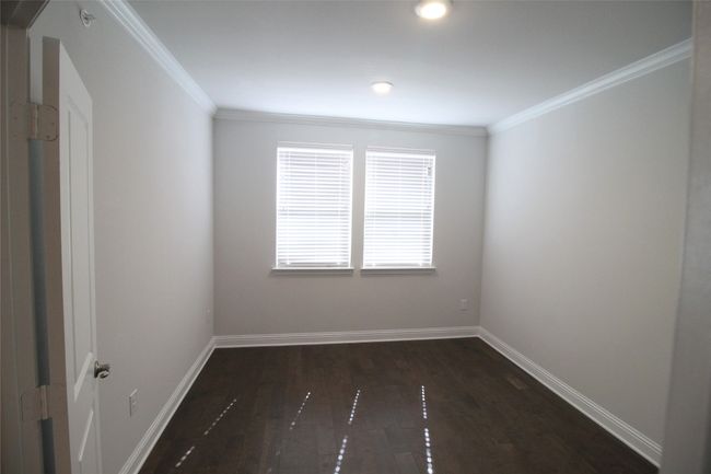 Unfurnished room with dark wood-style floors, baseboards, and ornamental molding | Image 8