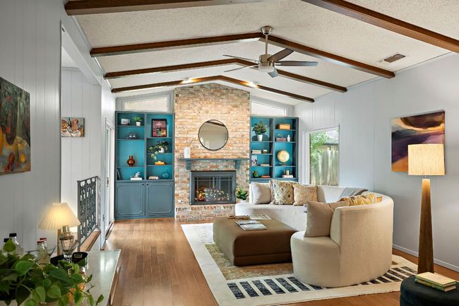 Built-in bookcases and a substantial fireplace create warmth | Image 10