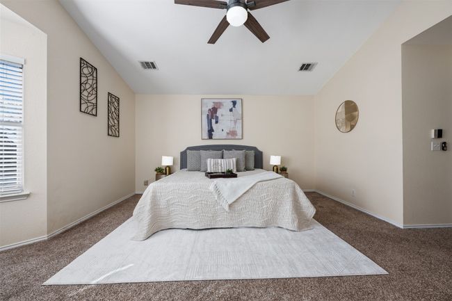 Bedroom featuring vaulted ceiling, visible vents, and carpet floors | Image 22