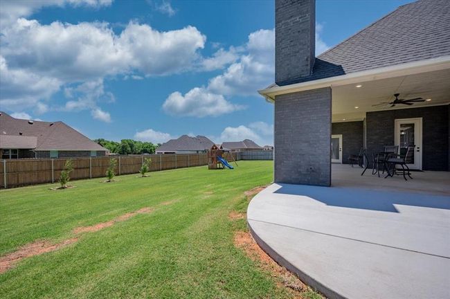 View of yard with a playground, a patio area, and a ceiling fan | Image 7