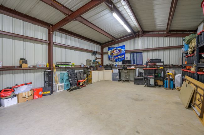 Garage featuring a workshop area and metal wall | Image 31