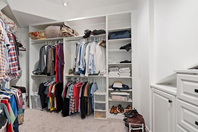 Impressive second closet, featuring built-in shelves and storage. Thoughtfully designed for both convenience and style, complementing the home’s luxury elements. | Image 25