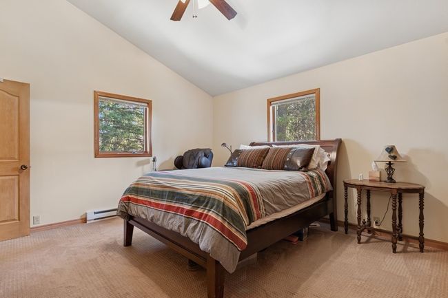Bedroom featuring baseboard heater for individual room temperature control. | Image 53