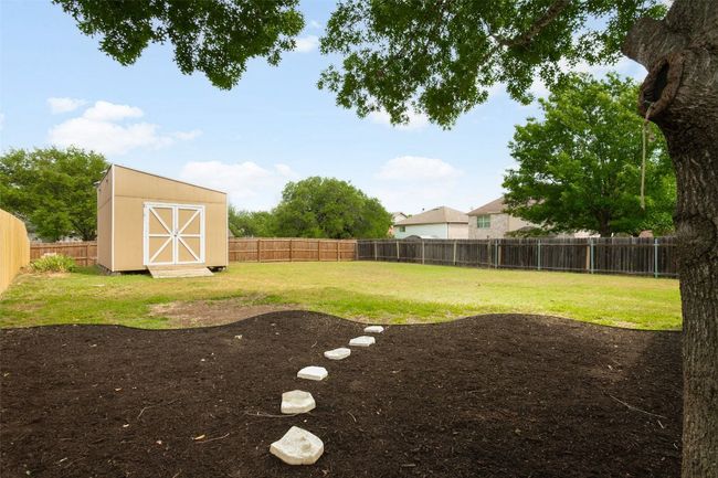 Explore your ideal home, complete with a large backyard that has the potential for a stunning pool, making it perfect for gatherings and outdoor fun! This expansive yard presents limitless opportunities—whether you picture a vibrant garden, a playground for children, or a peaceful escape for unwinding—all while allowing space for a pool. Seize this unique chance to own a property with a yard that genuinely elevates your lifestyle. | Image 35