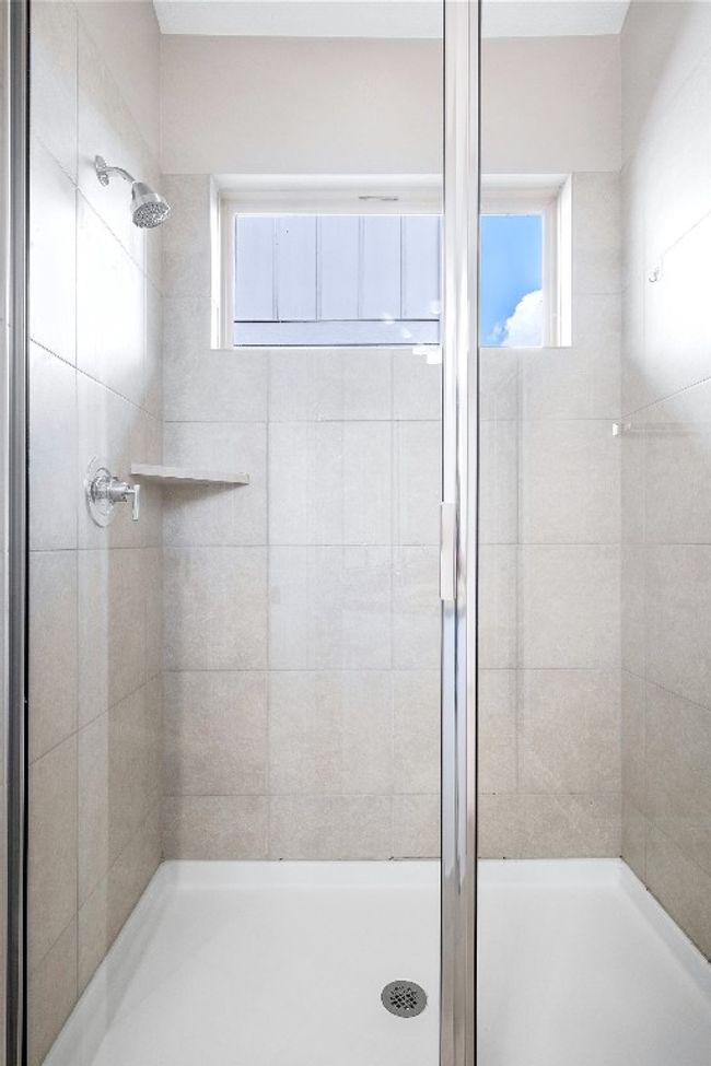 Full bathroom featuring a stall shower and healthy amount of natural light | Image 27