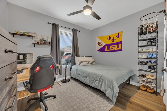 Bedroom featuring baseboards, wood finished floors, and a ceiling fan | Image 7