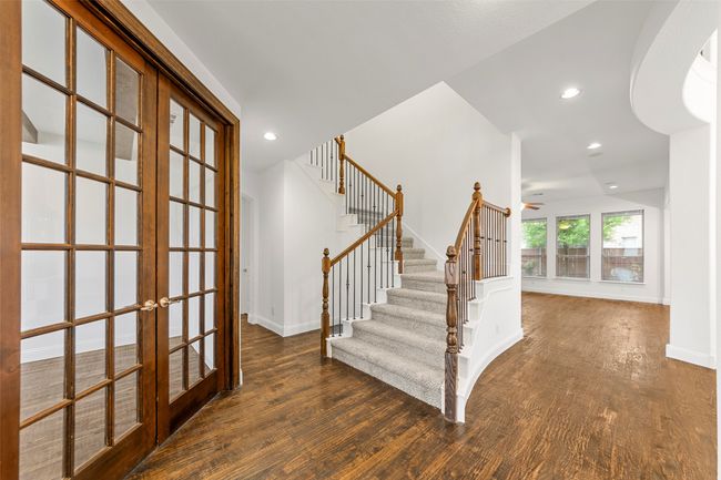 Stairway with ceiling fan, french doors, wood finished floors, baseboards, and recessed lighting | Image 4
