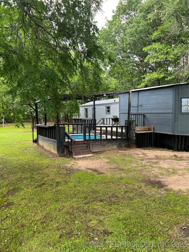 View of grassy yard featuring a wooden deck | Image 37