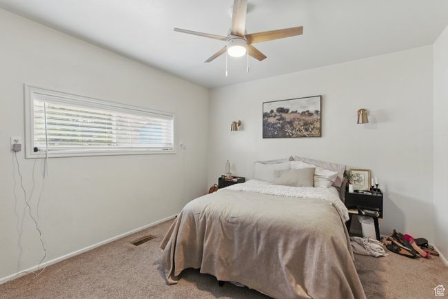 Carpeted bedroom with visible vents, a ceiling fan, and baseboards | Image 12