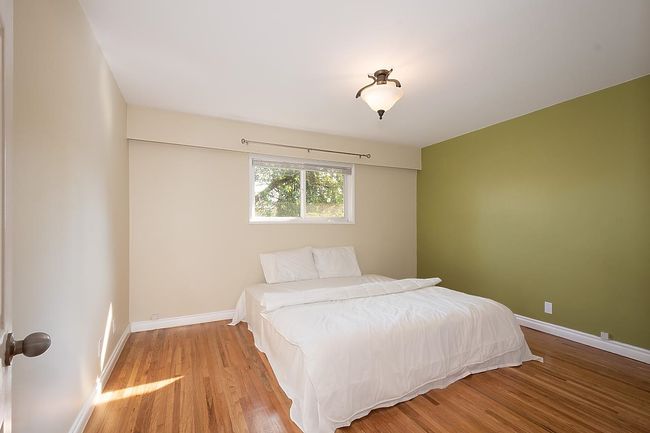 Bedroom with wood finished floors and baseboards | Image 17