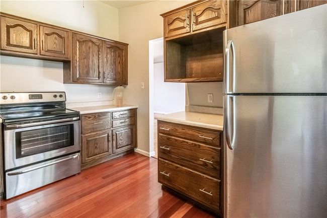 The kitchen is outfitted with stainless steel appliances and access to the backyard. | Image 8