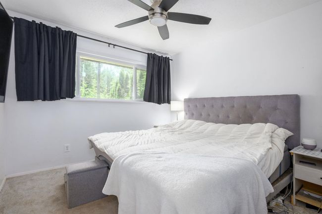 Bedroom featuring carpet flooring, a ceiling fan, and baseboards | Image 21