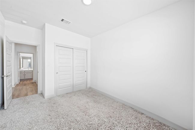 Unfurnished bedroom with visible vents, baseboards, a closet, and carpet | Image 5