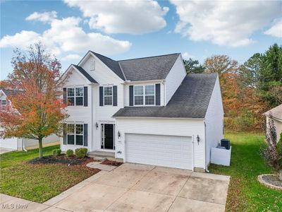 View of front facade with central AC, a front lawn, and a garage | Image 3