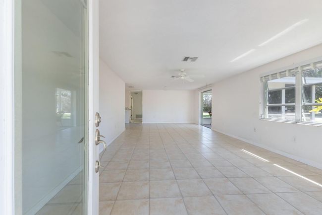 Enter into a large open great room and dining area. | Image 5