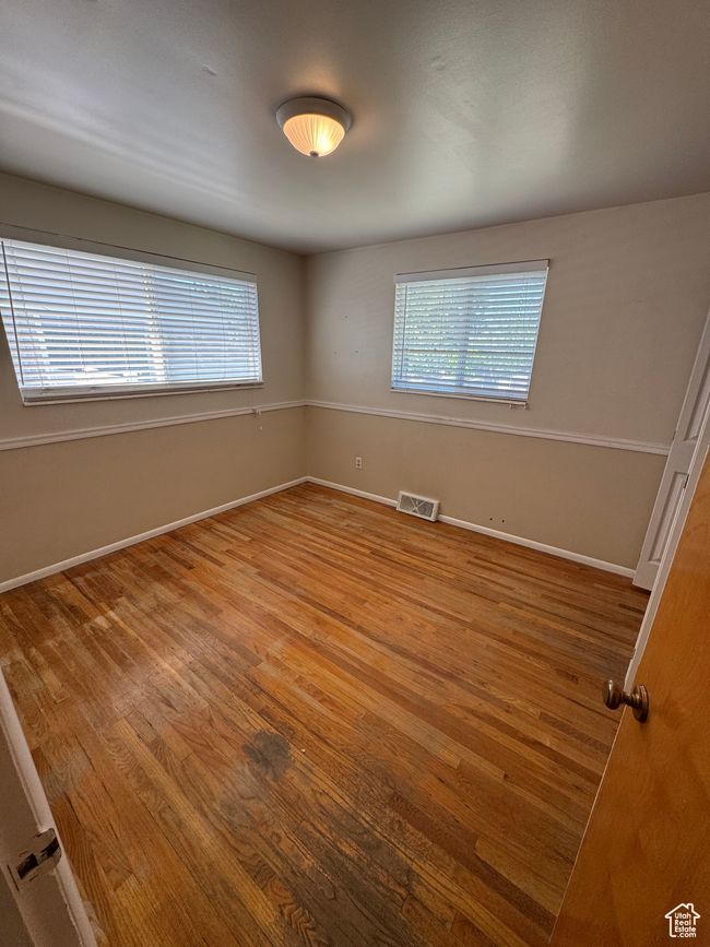 Spare room with wood finished floors and healthy amount of natural light | Image 9