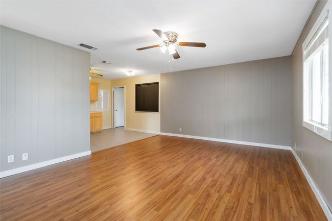 Unfurnished room featuring baseboards, visible vents, a ceiling fan, and light wood finished floors | Image 8
