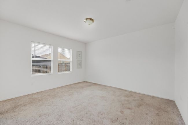 The large windows in the primary bedroom allow natural light to fill the space, creating a bright, airy feel. | Image 14