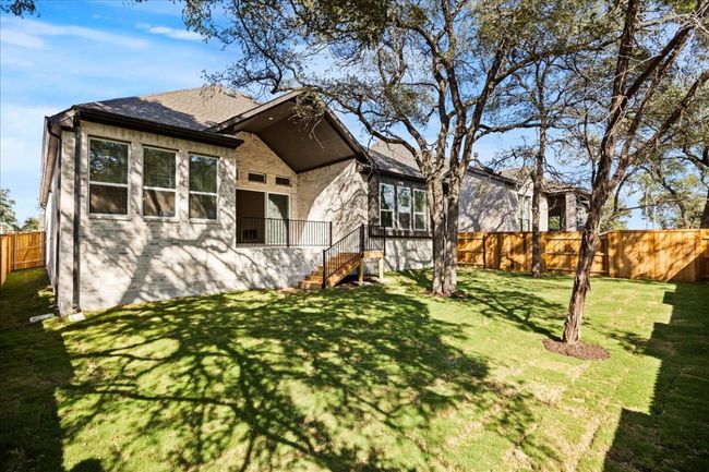 View of front of house with brick siding, roof with shingles, and stairway | Image 23