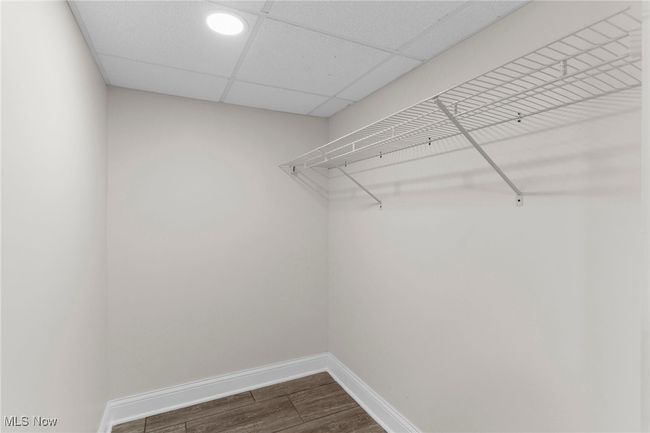 Walk in closet with dark wood-style floors and a paneled ceiling | Image 30