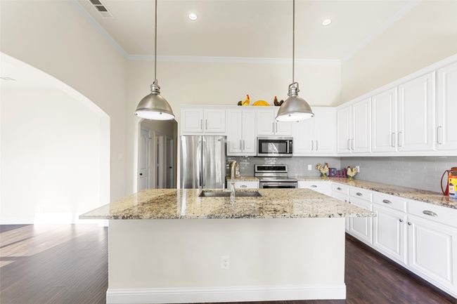 View of Kitchen straight on and another hallway leading to third bathroom & pantry! | Image 13