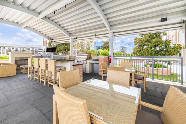 Outdoor entertainment oasis with grill and spacious seating for guests. | Image 30