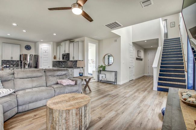 Living area featuring a ceiling fan, stairway, recessed lighting, and light wood-type flooring | Image 6
