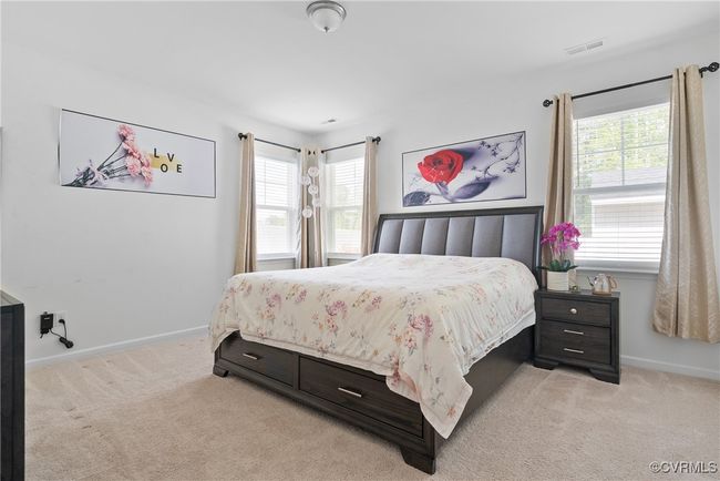 Bedroom featuring baseboards, visible vents, and light carpet | Image 16