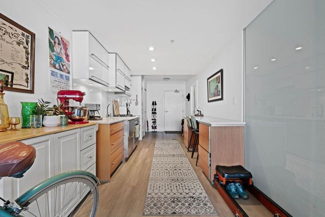 Kitchen featuring recessed lighting, light wood-type flooring, light countertops, and white cabinetry | Image 6