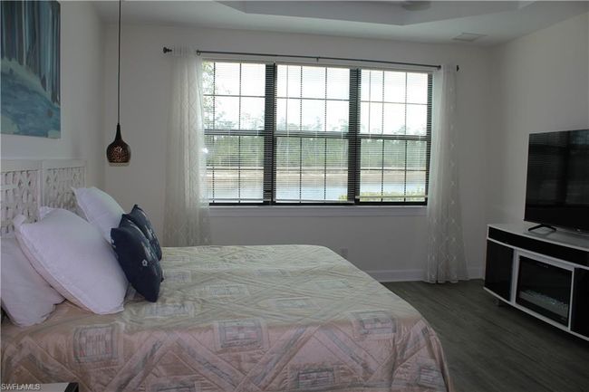 Master Bedroom featuring baseboards, multiple windows, and wood finished floors | Image 16