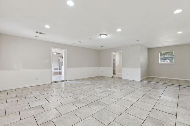 Empty room with wainscoting, recessed lighting, ceiling fan, and light tile patterned flooring | Image 4