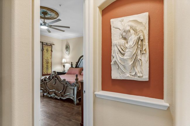 Hallway with ornamental molding and wood finished floors | Image 18