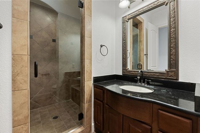 Full bath with a textured wall, a stall shower, and vanity | Image 5
