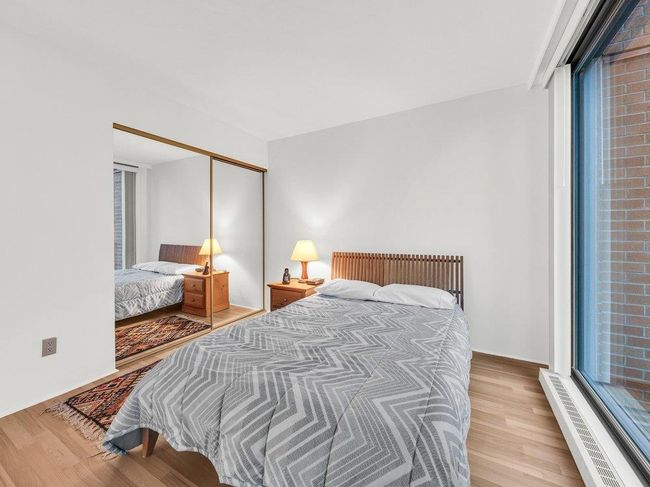 Bedroom with a closet and wood finished floors | Image 11