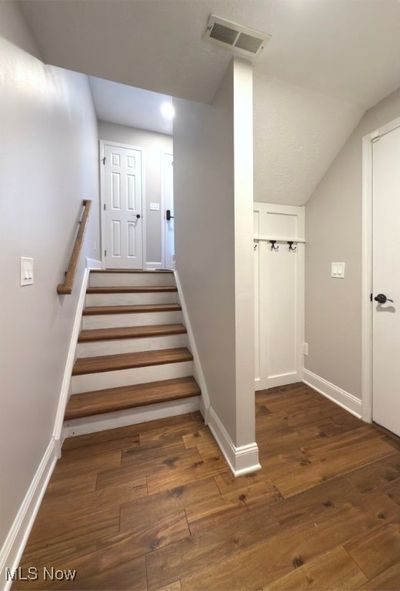 Entering through the 2 car garage entry way, a hidden storage area behind door with coat hooks. | Image 2