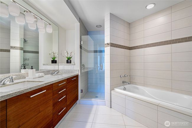 Master bathroom with glass-enclosed shower and deep soaking tub. | Image 14