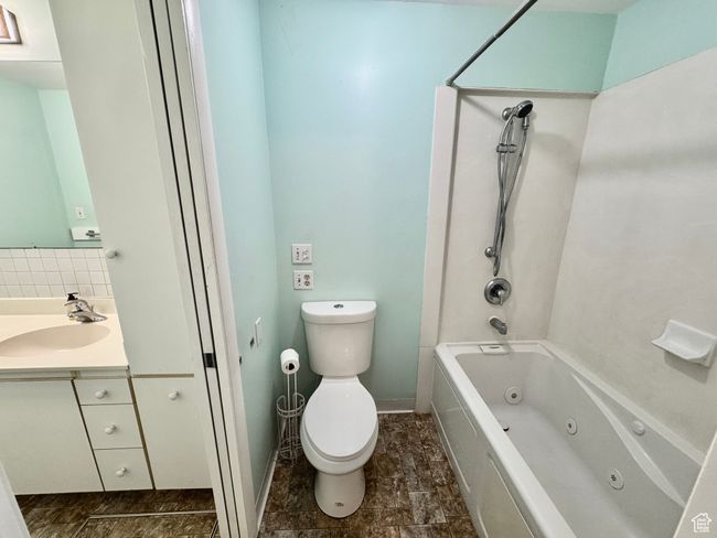 Full bath with a combined bath / shower with jetted tub, vanity, and toilet | Image 31