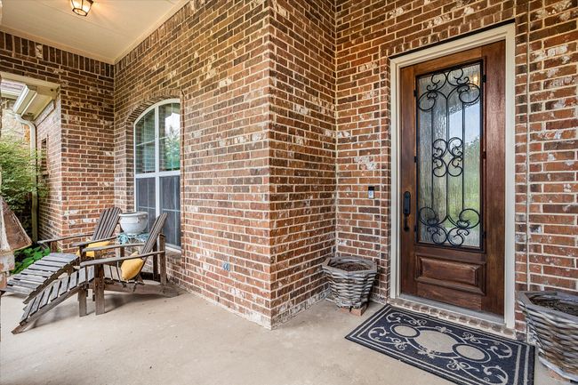 View of exterior entry featuring brick siding | Image 5