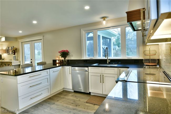 Kitchen with dishwasher, a sink, a peninsula, recessed lighting, and light wood-style flooring | Image 16