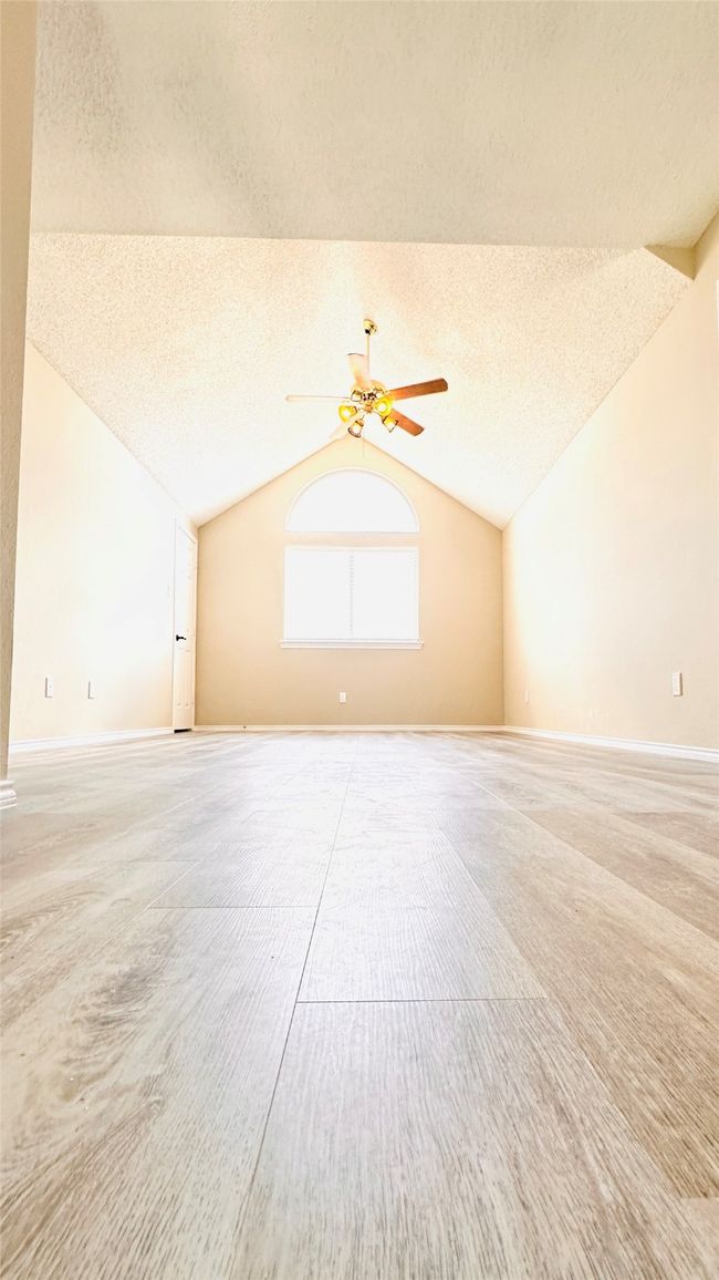 Bonus room with vaulted ceiling, a textured ceiling, and a ceiling fan | Image 7