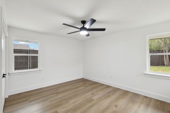 Spare room featuring baseboards, light wood-style flooring, and a ceiling fan | Image 22