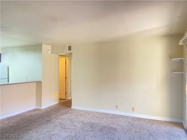 Carpeted spare room with visible vents, baseboards, and a textured ceiling | Image 5